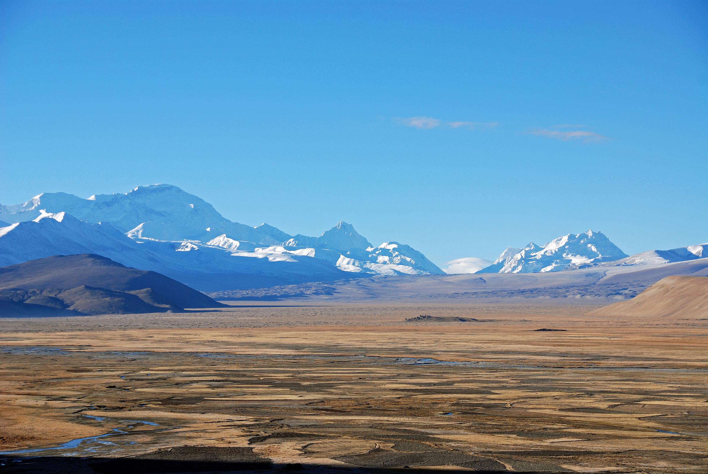 09 Cho Oyu, Nangpai Gosum I, Nangpa La, Jobo Rabzang Early Morning From Across Tingri Plain The view across the plains from Tingri include Cho Oyu (8201m), the pointed peak Nangpai Gosum I (7351m, also called Pasang Lhamu Chuli, Josamba and Cho Aui), the Nangpa La pass between Tibet and Nepal, and Jobo Rabzang (6666m) on the right.